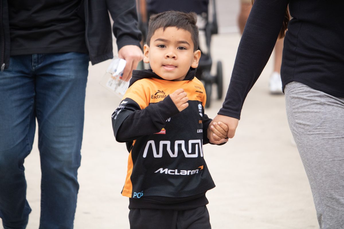 A young fan wearing McLaren race gear at the 2025 Acura Grand Prix of Long Beach. 