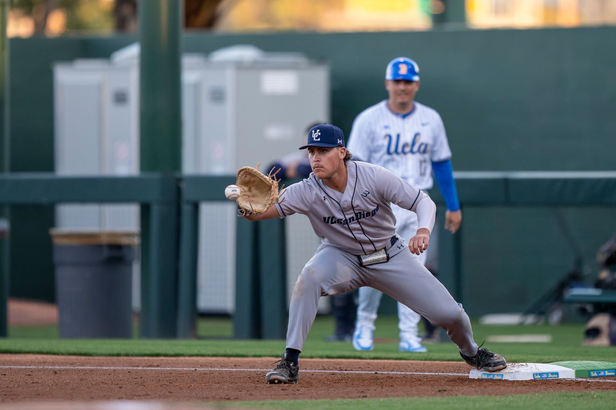 UC San Diego infielder, Gabe Camacho (34) catching a passed ball for an out at first base during a NCAA baseball game against UC San Diego on February 13, 2026 at Jackie Robinson Stadium in Los Angeles, CA. UC San Diego infielder, Gabe Camacho (34) catching a passed ball for an out at first base during a NCAA baseball game against UC San Diego on February 13, 2026 at Jackie Robinson Stadium in Los Angeles, CA.