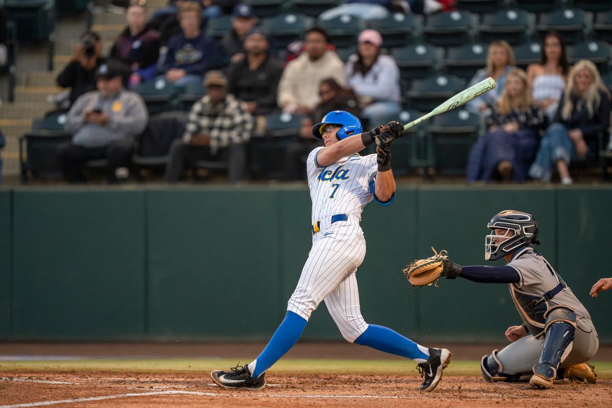 UCLA infielder, Roman Martin (7), at bat, mid-hit during a NCAA baseball game against UC San Diego on February 13, 2026 at Jackie Robinson Stadium in Los Angeles, CA. UCLA infielder, Roman Martin (7), at bat, mid-hit during a NCAA baseball game against UC San Diego on February 13, 2026 at Jackie Robinson Stadium in Los Angeles, CA.