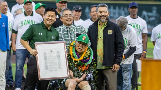 Senator Troy Hashimoto (left) and Representative Andrew Takuya Garrett (right) present coach Les Murakami with a proclamation. 
