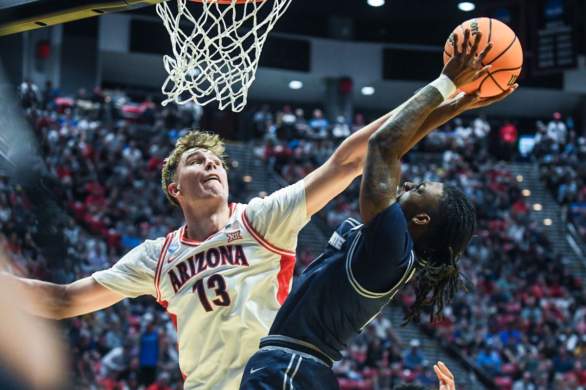 Arizona center Motiejus Krivas (13) contest the shot of Utah State guard Kolby King (7) during an NCAA East Region second round game against Utah State Sunday March 22, 2026 in San Diego, California. Arizona center Motiejus Krivas (13) contest the shot of Utah State guard Kolby King (7) during an NCAA East Region second round game against Utah State Sunday March 22, 2026 in San Diego, California.
