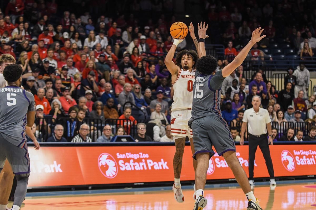 Wisconsin guard Braeden Carrington (0) shoots a three point shot over TCU forward David Punch (15) during an NCAA basketball game against TCU, Friday November 28, 2025 in San Diego, California. Wisconsin guard Braeden Carrington (0) shoots a three point shot over TCU forward David Punch (15) during an NCAA basketball game against TCU, Friday November 28, 2025 in San Diego, California.