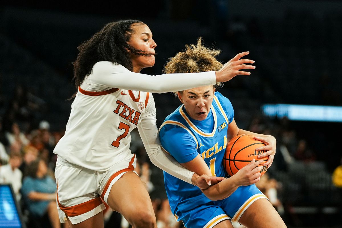 UCLA guard Kiki Rice (1) drives towards the basket while guarded by Texas Jordan Lee (7) during second half of college basketball game against Texas on Wednesday, Nov. 26, 2025 during the Players Era tournament at Michelob Ultra Arena in Las Vegas. UCLA guard Kiki Rice (1) drives towards the basket while guarded by Texas Jordan Lee (7) during second half of college basketball game against Texas on Wednesday, Nov. 26, 2025 during the Players Era tournament at Michelob Ultra Arena in Las Vegas.