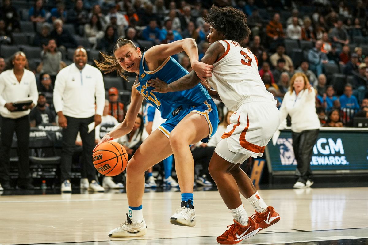 UCLA forward Justice Carlton (11) attempts to drive into the paint while guarded by Texas guard Rori Harmon (3) during second half of college basketball game against Texas on Wednesday, Nov. 26, 2025 during the Players Era tournament at Michelob Ultra Arena in Las Vegas. UCLA forward Justice Carlton (11) attempts to drive into the paint while guarded by Texas guard Rori Harmon (3) during second half of college basketball game against Texas on Wednesday, Nov. 26, 2025 during the Players Era tournament at Michelob Ultra Arena in Las Vegas.
