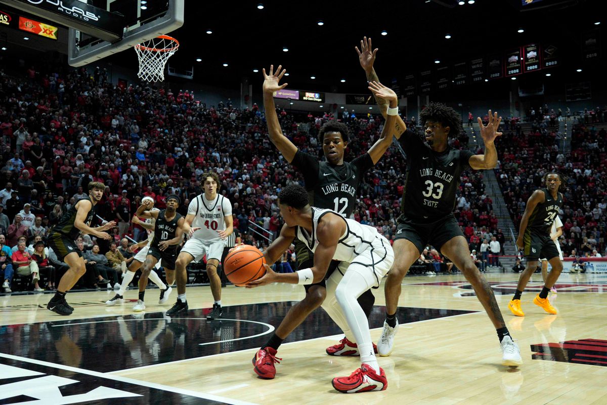 San Diego State guard Sean Newman Jr. (4) passes during an NCAA Basketball game against Long Beach State, Tuesday November 4, 2025 in San Diego, Calif. San Diego State guard Sean Newman Jr. (4) passes during an NCAA Basketball game against Long Beach State, Tuesday November 4, 2025 in San Diego, Calif.