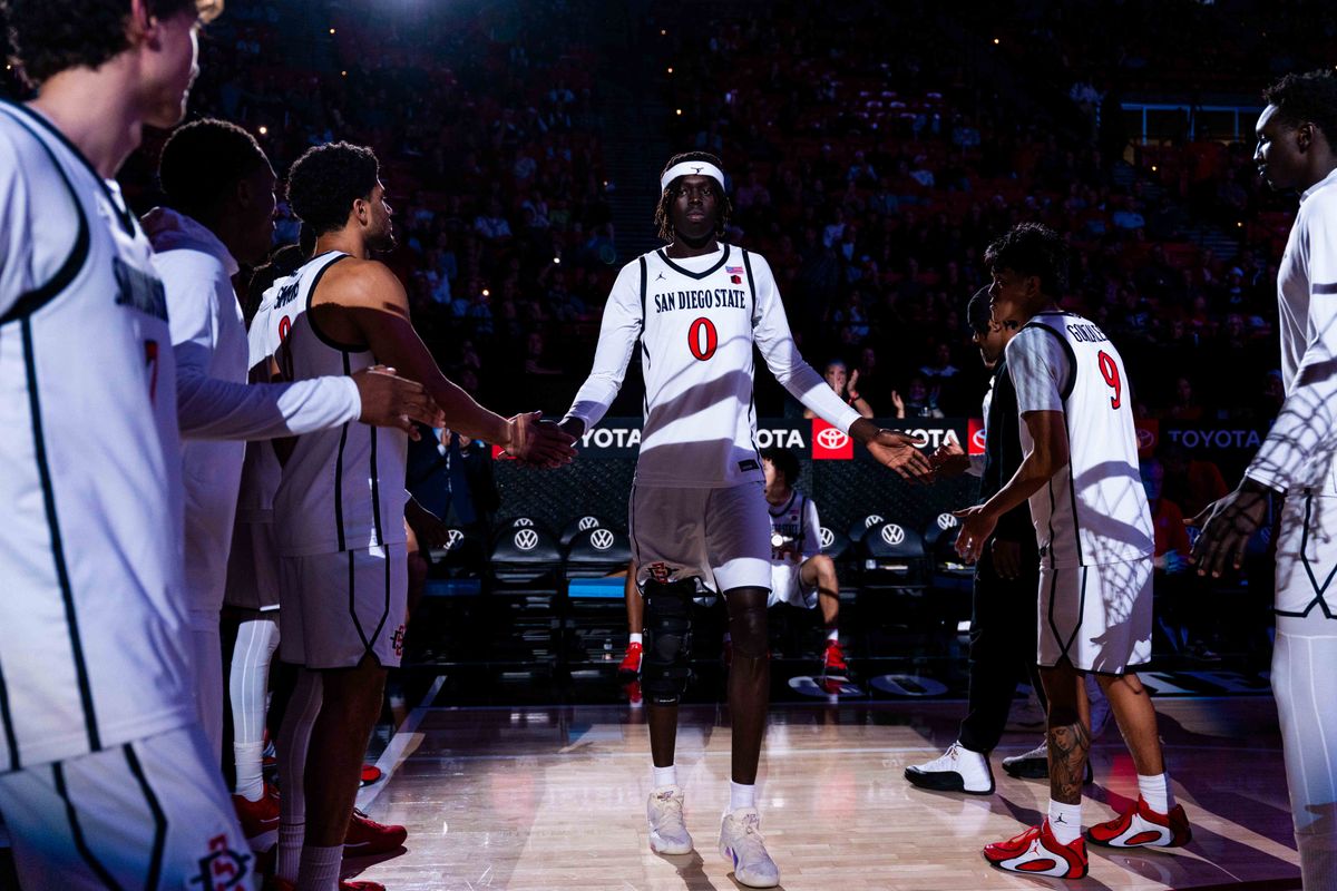 San Diego State forward Magoon Gwath (0) is introduced before an NCAA Basketball game between Whittier and San Diego State, Monday December 22, 2025 at Viejas Arena in San Diego, Calif. San Diego State forward Magoon Gwath (0) is introduced before an NCAA Basketball game between Whittier and San Diego State, Monday December 22, 2025 at Viejas Arena in San Diego, Calif.