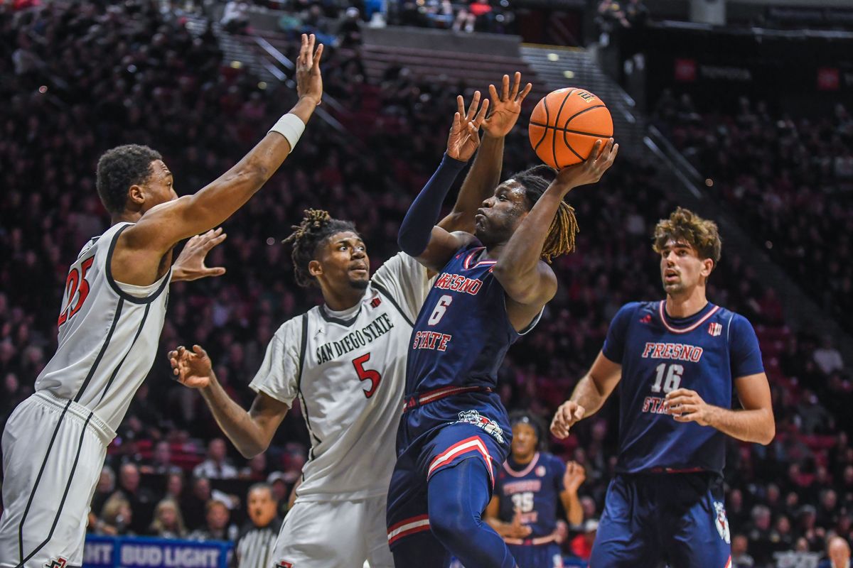 Fresno State DJ Stickman (6) takes a contested shot against the defense of SDSU Pharaoh Compton (5) during an NCAA men’s basketball game against SDSU. Saturday January 10, 2026 in San Diego, California. Fresno State DJ Stickman (6) takes a contested shot against the defense of SDSU Pharaoh Compton (5) during an NCAA men’s basketball game against SDSU. Saturday January 10, 2026 in San Diego, California.