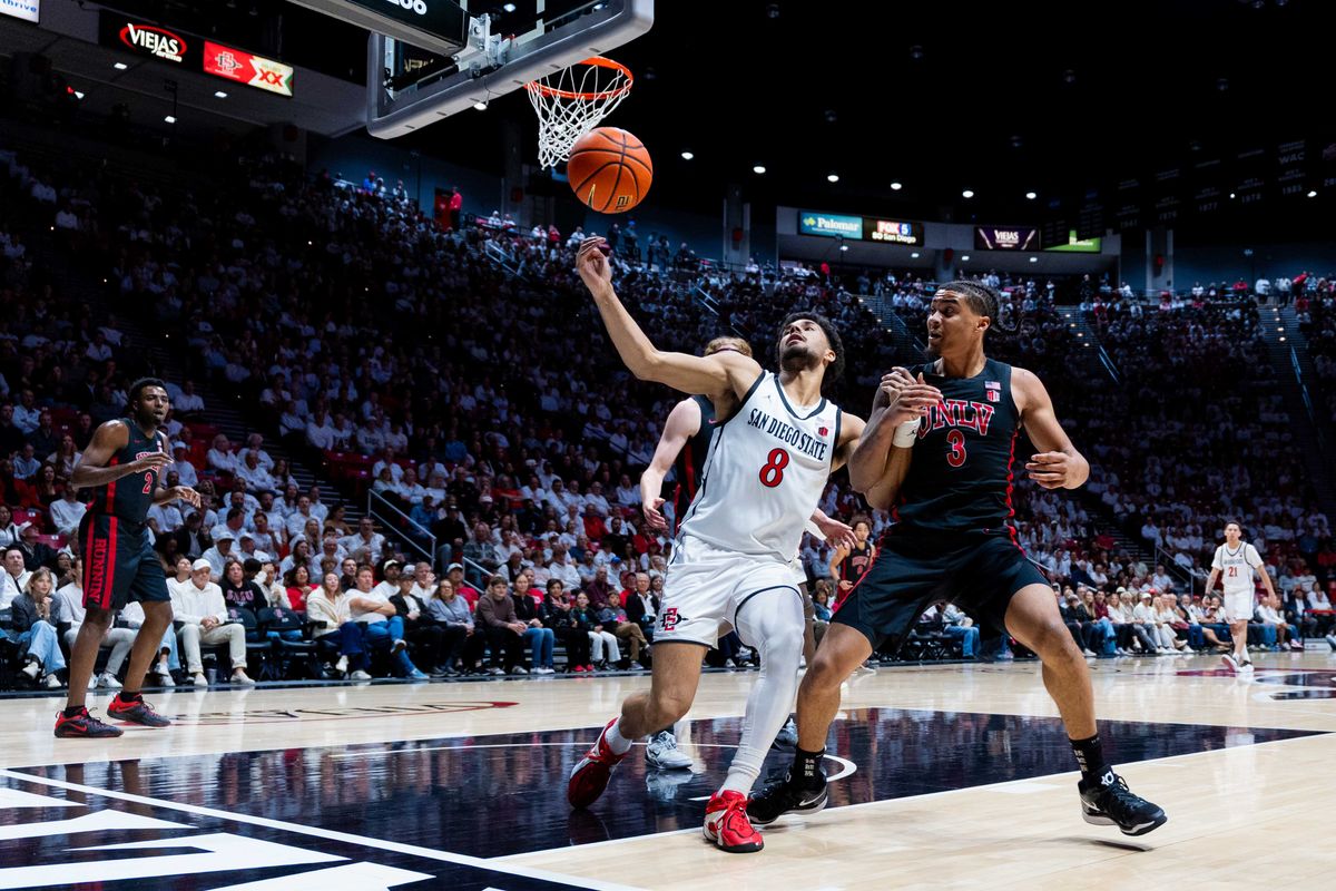 San Diego State forward Tae Simmons (8) tries to save the ball during an NCAA Basketball game between UNLV and San Diego State, Friday March 6, 2026 at Viejas Arena in San Diego, Calif. San Diego State forward Tae Simmons (8) tries to save the ball during an NCAA Basketball game between UNLV and San Diego State, Friday March 6, 2026 at Viejas Arena in San Diego, Calif.