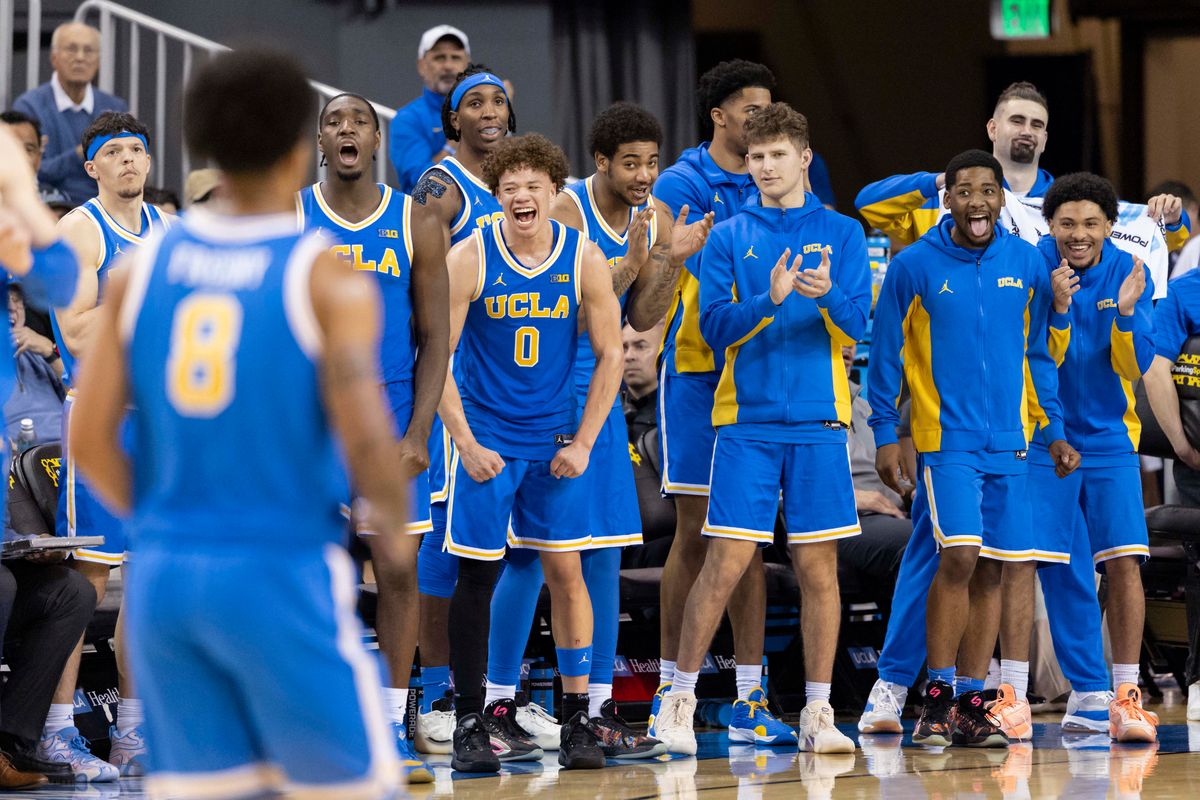 The UCLA Bruins bench celebrates a made three point shot by Eric Freeny #8 during an NCAA basketball game against the USC Trojans, Tuesday February 24, 2026 in Los Angeles, Calif.