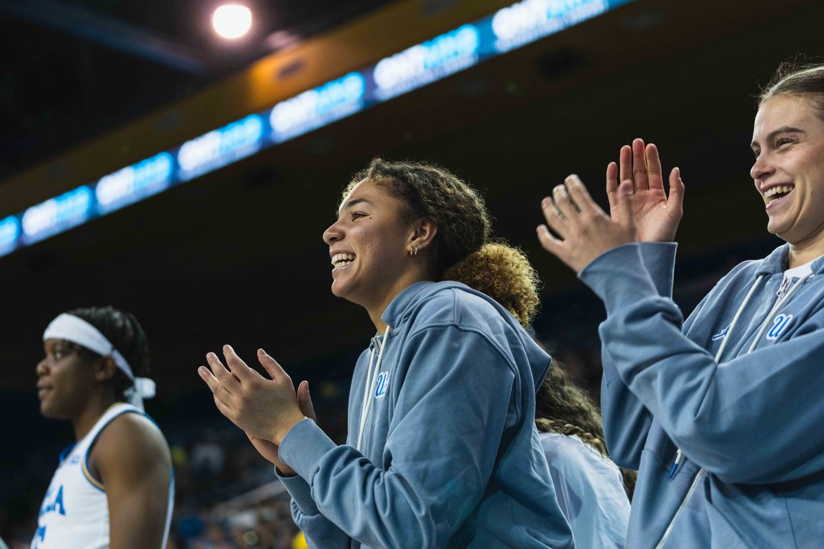 UCLA Bruins Guard Kiki Rice (1) cheering on the team from the sidelines during an NCAA basketball game against Colgate, Sunday November 10th, 2024 in Los Angeles, California.