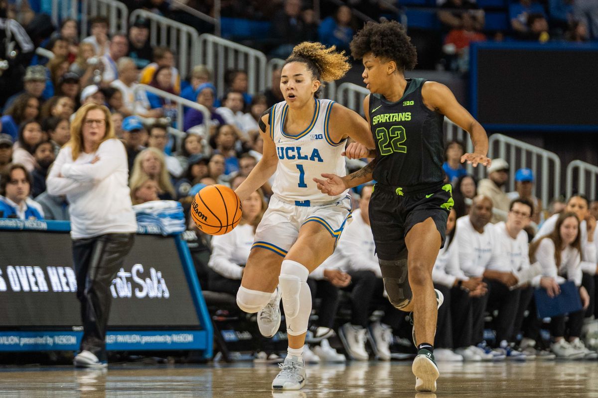 UCLA guard Kiki Rice (1) drives to the basket in a game against Michigan State, Sunday February 16, 2025 in Los Angeles, Calif.