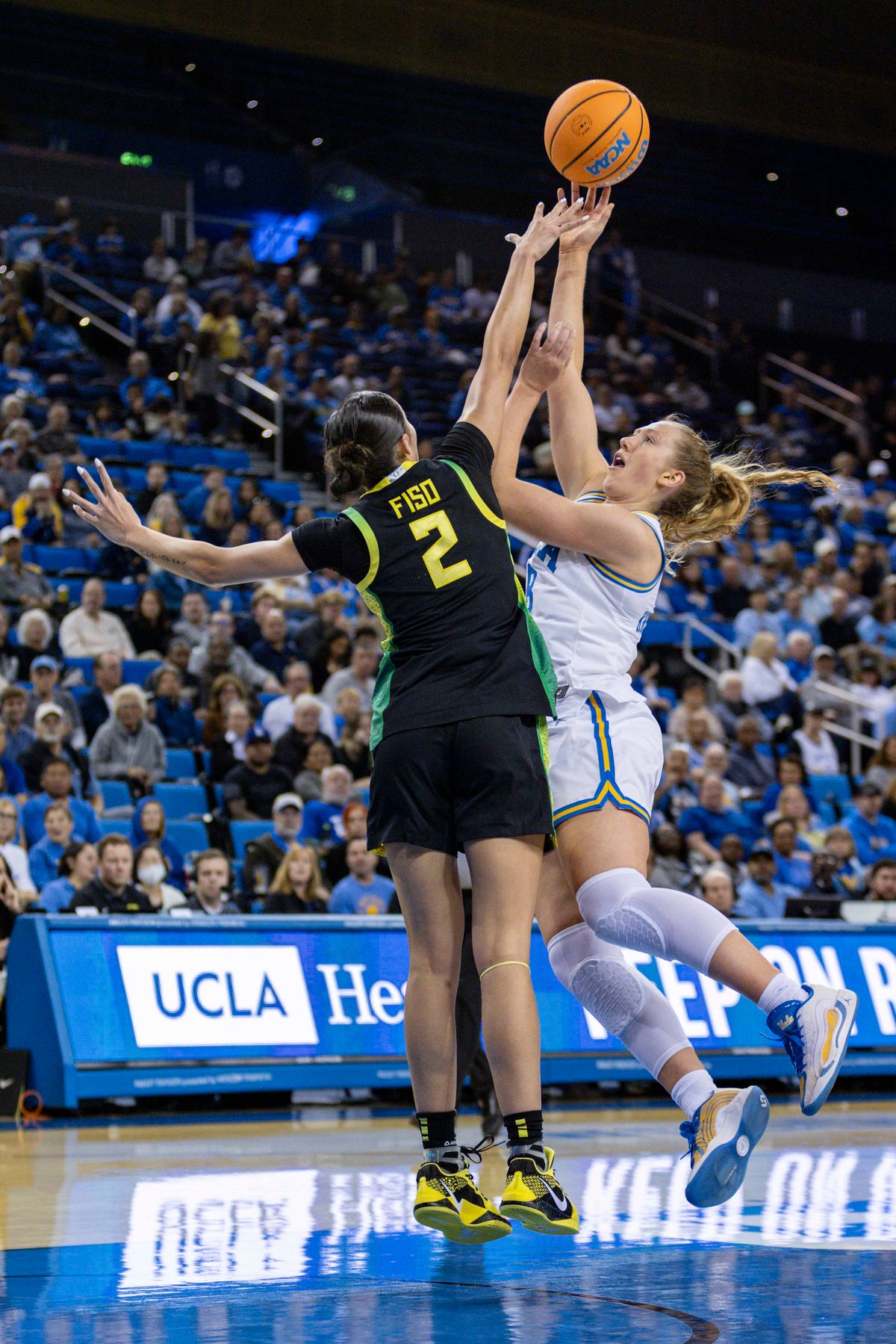 Guard Gianna Kneepkens #8 of the UCLA Bruins shoots the ball over guard Katie Fiso #2 of the Oregon Ducks during an NCAA basketball game, Sunday December 7, 2025 in Los Angeles, Calif. Guard Gianna Kneepkens #8 of the UCLA Bruins shoots the ball over guard Katie Fiso #2 of the Oregon Ducks during an NCAA basketball game, Sunday December 7, 2025 in Los Angeles, Calif.