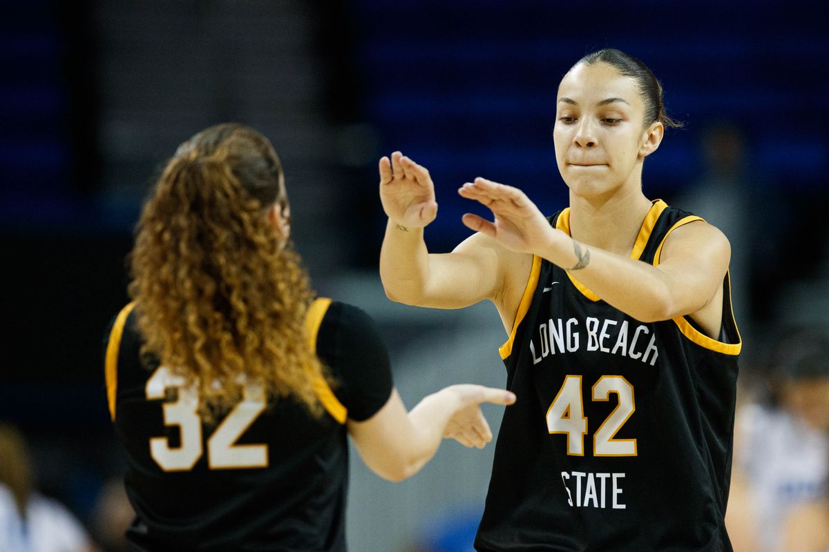 Long Beach State forward Judit Oliva Fernandez (42) high fives guard Brynna Pukis (32) during an NCAA basketball game against the UCLA Bruins, Saturday December 20, 2025 in Los Angeles, Calif. Long Beach State forward Judit Oliva Fernandez (42) high fives guard Brynna Pukis (32) during an NCAA basketball game against the UCLA Bruins, Saturday December 20, 2025 in Los Angeles, Calif.