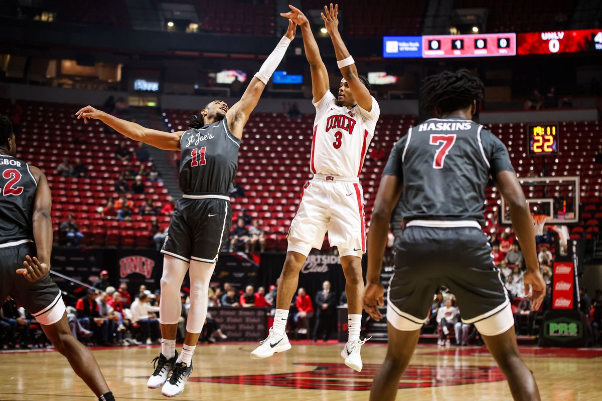 UNLV Runnin' Rebels G Howie Fleming Jr. (3) shoots a three-point shot over Saint Joseph's Hawks G Jaiden Glover-Toscano (11) during an NCAA basketball game on Thursday November 20, 2025, in Las Vegas, Nevada. UNLV Runnin' Rebels G Howie Fleming Jr. (3) shoots a three-point shot over Saint Joseph's Hawks G Jaiden Glover-Toscano (11) during an NCAA basketball game on Thursday November 20, 2025, in Las Vegas, Nevada.