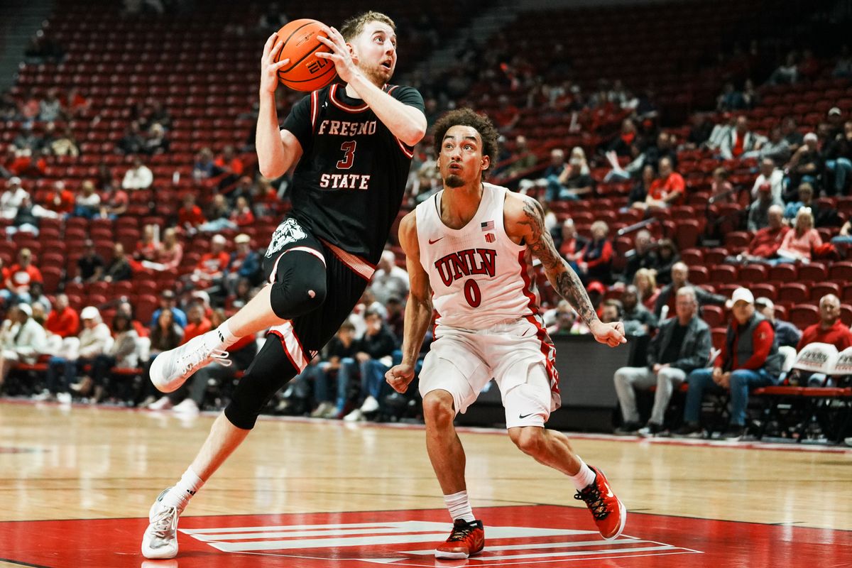 Fresno guard Jake Heidbreder (3) launches towards the basket over UNLV Dravyn Gibbs-Lawhorn (0) during first half of college basketball game against UNLV on Sat., Dec. 20, 2025, at Thomas & Mack Center in Las Vegas. Fresno guard Jake Heidbreder (3) launches towards the basket over UNLV Dravyn Gibbs-Lawhorn (0) during first half of college basketball game against UNLV on Sat., Dec. 20, 2025, at Thomas & Mack Center in Las Vegas.