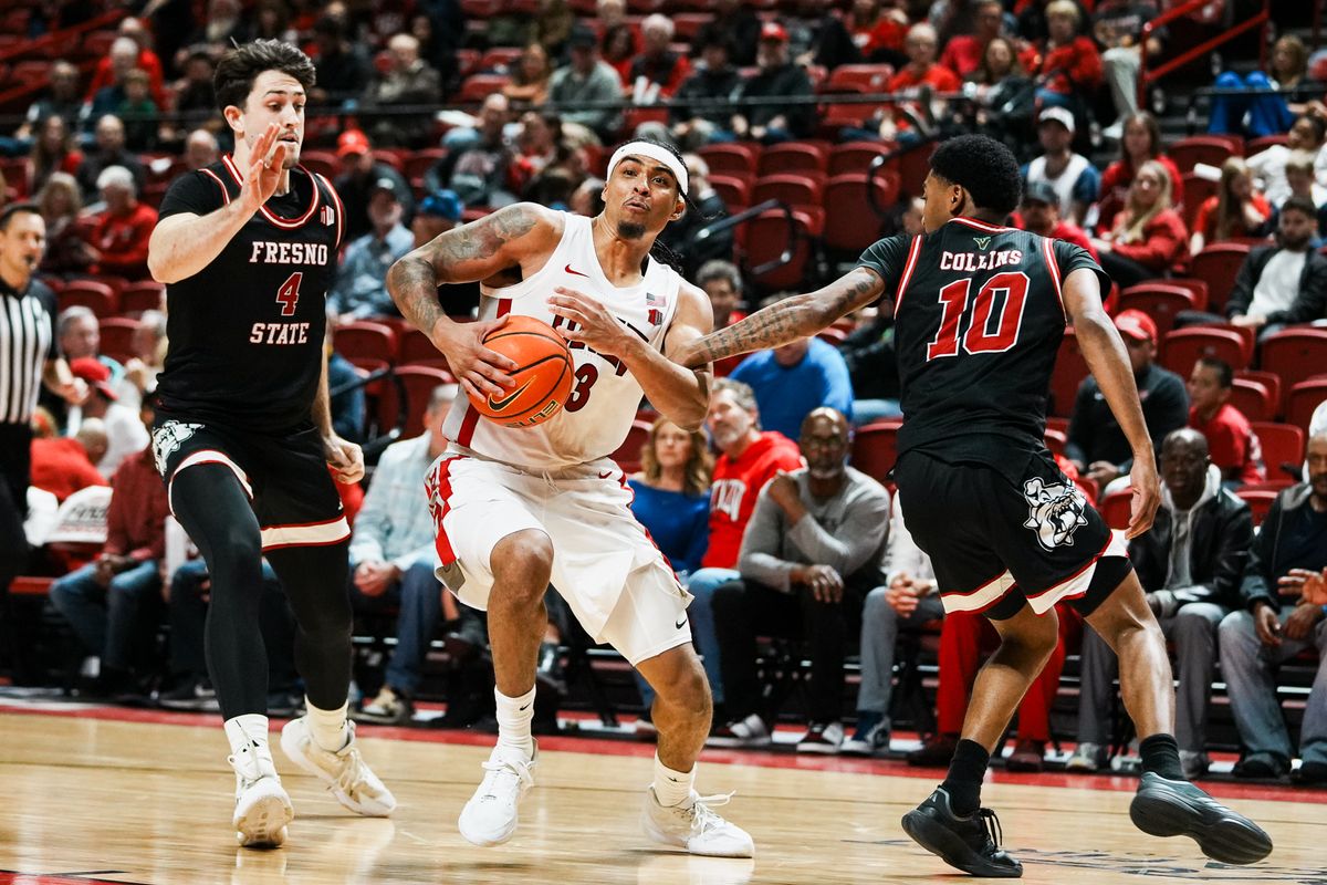 UNLV guard Howie Fleming Jr. (3) takes the ball past Fresno Cameron Fass (4) and Zaon Collins (10) during second half of college basketball game against Fresno State on Sat., Dec. 20, 2025, at Thomas & Mack Center in Las Vegas. UNLV guard Howie Fleming Jr. (3) takes the ball past Fresno Cameron Fass (4) and Zaon Collins (10) during second half of college basketball game against Fresno State on Sat., Dec. 20, 2025, at Thomas & Mack Center in Las Vegas.