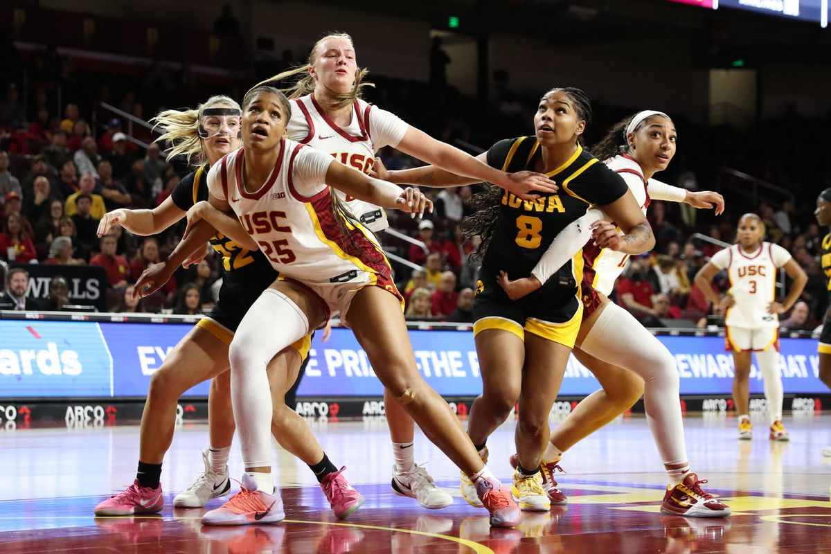 USC Trojan and Iowa Hawkeyes player box out for a rebound during an NCAA basketball game on January 29, 2026 in Los Angeles, CA. USC Trojan and Iowa Hawkeyes player box out for a rebound during an NCAA basketball game on January 29, 2026 in Los Angeles, CA.