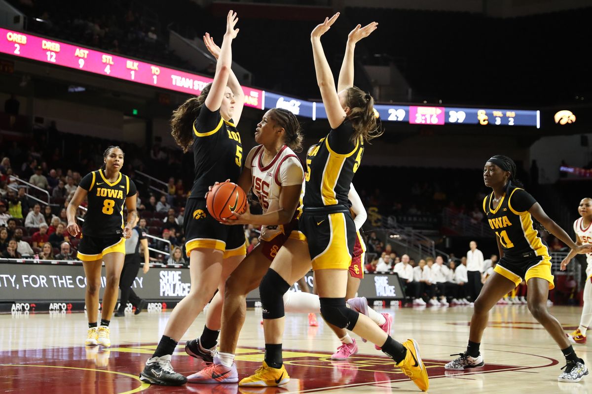 USC guard Kara Dunn (25) drives between two defenders during an NCAA basketball game against the Iowa Hawkeyes on January 29, 2026 in Los Angeles, CA. USC guard Kara Dunn (25) drives between two defenders during an NCAA basketball game against the Iowa Hawkeyes on January 29, 2026 in Los Angeles, CA.