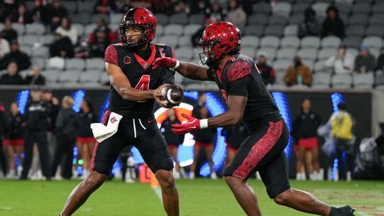 San Diego State University quarterback Jayden Denegal (4) hands the ball to San Diego State University running back Lucky Sutton (7) during an NCAA football game against Boise State, Saturday November 15, 2025 in San Diego, California. San Diego State University quarterback Jayden Denegal (4) hands the ball to San Diego State University running back Lucky Sutton (7) during an NCAA football game against Boise State, Saturday November 15, 2025 in San Diego, California.