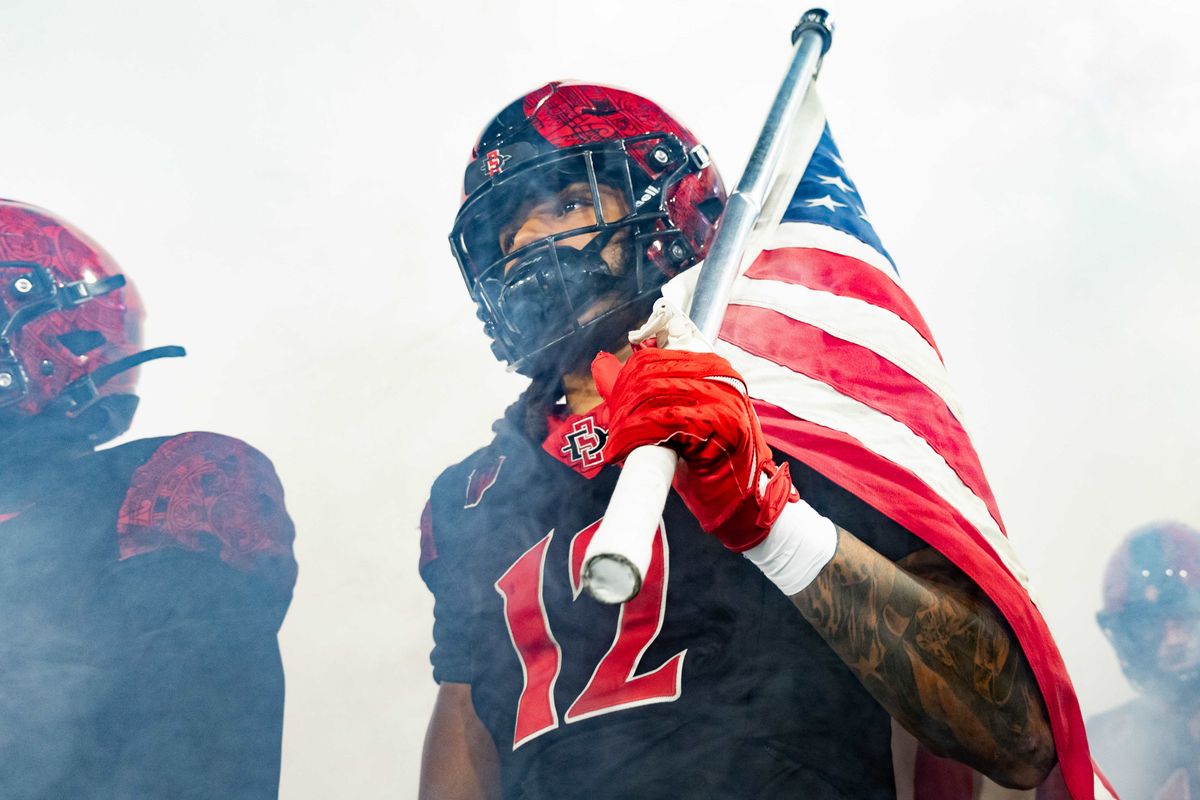 San Diego State linebacker Owen Chambliss (12) holds an American flag as his team is introduced during an NCAA Football game between San Jose State and San Diego State, Saturday November 22, 2025 in San Diego, Calif. San Diego State linebacker Owen Chambliss (12) holds an American flag as his team is introduced during an NCAA Football game between San Jose State and San Diego State, Saturday November 22, 2025 in San Diego, Calif.