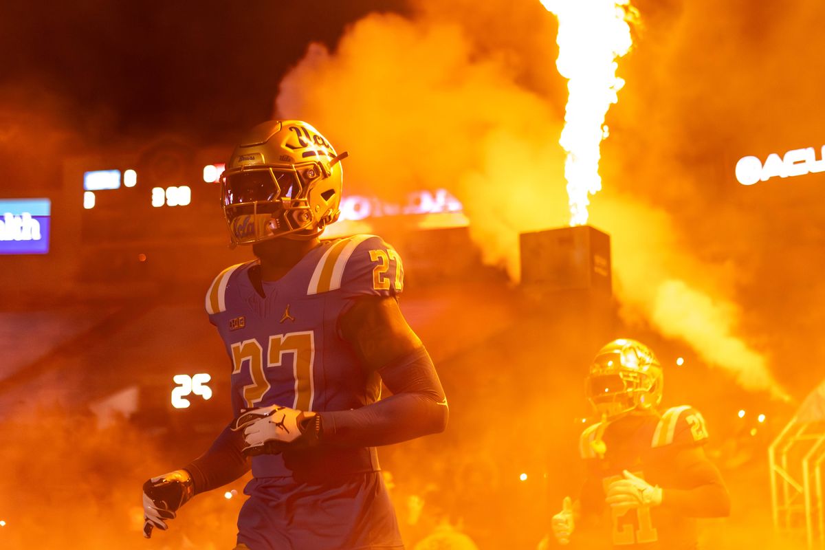 UCLA Bruins running back Isaiah Carlson (27) runs out of the smoke before the game against Nebraska Cornhuskers at Rose Bowl Stadium on November 8, 2025 in Pasadena, California. UCLA Bruins running back Isaiah Carlson (27) runs out of the smoke before the game against Nebraska Cornhuskers at Rose Bowl Stadium on November 8, 2025 in Pasadena, California.