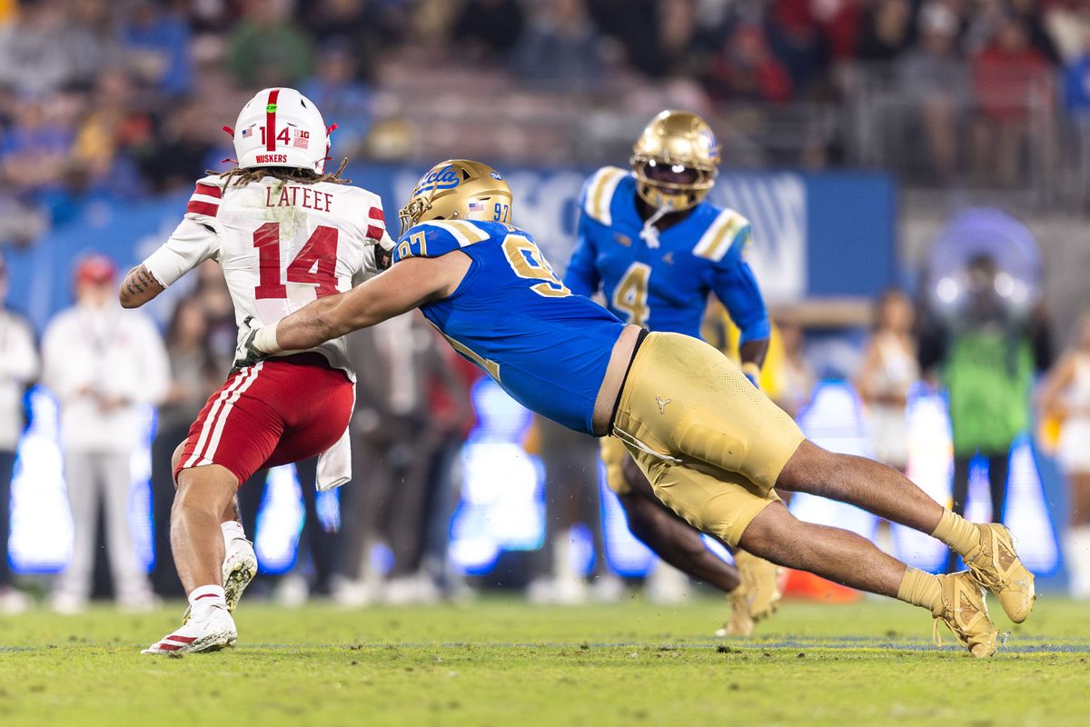 UCLA Bruins defensive lineman Jacob Busic (97) attempts to sack Nebraska Cornhuskers quarterback TJ Lateef (14) during the game against Nebraska Cornhuskers at Rose Bowl Stadium on November 8, 2025 in Pasadena, California. UCLA Bruins defensive lineman Jacob Busic (97) attempts to sack Nebraska Cornhuskers quarterback TJ Lateef (14) during the game against Nebraska Cornhuskers at Rose Bowl Stadium on November 8, 2025 in Pasadena, California.