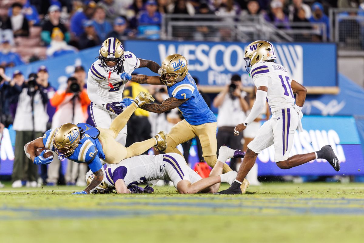 UCLA Bruins running back Jalen Berger (0) dives while getting tackled during the game against Washington Huskies at Rose Bowl Stadium on November 22, 2025 in Pasadena, California. UCLA Bruins running back Jalen Berger (0) dives while getting tackled during the game against Washington Huskies at Rose Bowl Stadium on November 22, 2025 in Pasadena, California.