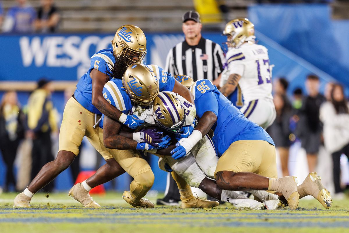 UCLA Bruins defensive lineman Jalen Hargrove (95) tackles Washington Huskies running back Adam Mohammed (24) during the game against Washington Huskies at Rose Bowl Stadium on November 22, 2025 in Pasadena, California. UCLA Bruins defensive lineman Jalen Hargrove (95) tackles Washington Huskies running back Adam Mohammed (24) during the game against Washington Huskies at Rose Bowl Stadium on November 22, 2025 in Pasadena, California.