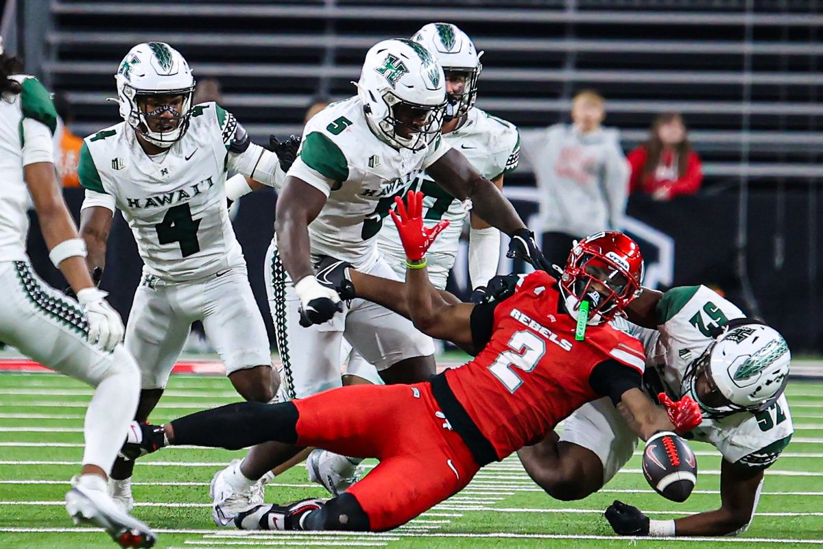 UNLV Rebels RB Keyvone Lee (2) loses possession of the ball after being tackled by several Hawai'i Rainbow Warriors players during a college football game on Friday November 21, 2025, in Las Vegas, Nevada. UNLV Rebels RB Keyvone Lee (2) loses possession of the ball after being tackled by several Hawai'i Rainbow Warriors players during a college football game on Friday November 21, 2025, in Las Vegas, Nevada.
