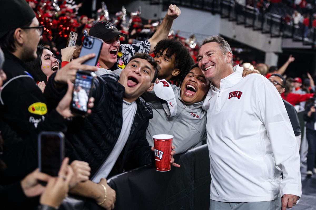 UNLV Rebels HC Dan Mullen poses with UNLV students after defeating the Hawai'i Rainbow Warriors in the 9th Island Showdown on Friday November 21, 2025, in Las Vegas, Nevada. UNLV Rebels HC Dan Mullen poses with UNLV students after defeating the Hawai'i Rainbow Warriors in the 9th Island Showdown on Friday November 21, 2025, in Las Vegas, Nevada.