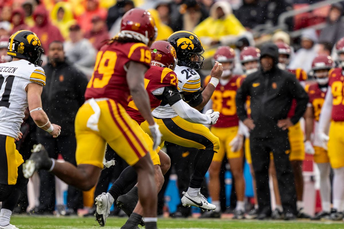 Iowa Hawkeyes running back, Kamari Moulton (28) rushes past defenders during an NCAAF football game against the USC Trojans on November 15, 2025 in Los Angeles, CA. Iowa Hawkeyes running back, Kamari Moulton (28) rushes past defenders during an NCAAF football game against the USC Trojans on November 15, 2025 in Los Angeles, CA.