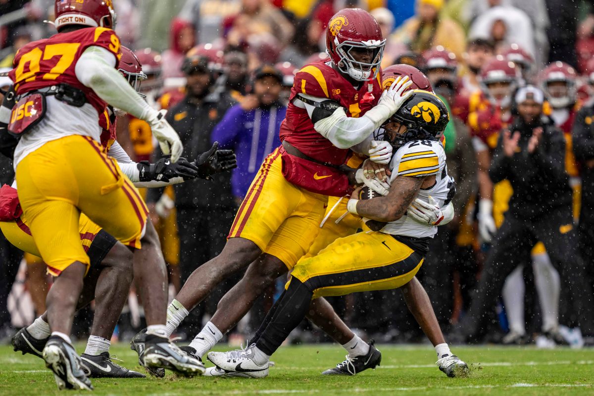 Iowa Hawkeyes running back, Kamari Moulton (28) is tackled by multiple defenders during an NCAAF football game against the USC Trojans on November 15, 2025 in Los Angeles, CA. Iowa Hawkeyes running back, Kamari Moulton (28) is tackled by multiple defenders during an NCAAF football game against the USC Trojans on November 15, 2025 in Los Angeles, CA.
