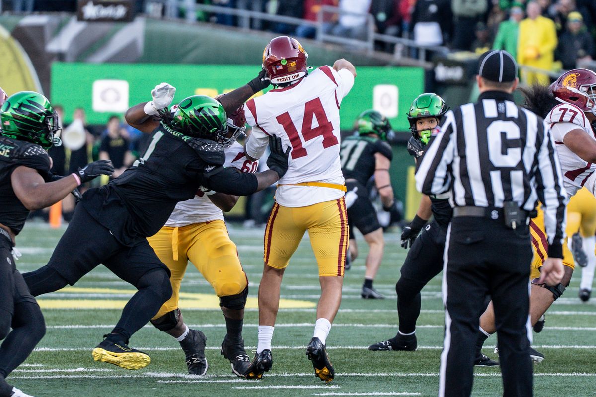 USC Trojans quarterback , Jayden Maiava (14) throws a pass in the middle while have his helmet slapped during an NCAAF football game against the Oregon Ducks on November 22, 2025 in Eugene, OR. USC Trojans quarterback , Jayden Maiava (14) throws a pass in the middle while have his helmet slapped during an NCAAF football game against the Oregon Ducks on November 22, 2025 in Eugene, OR.