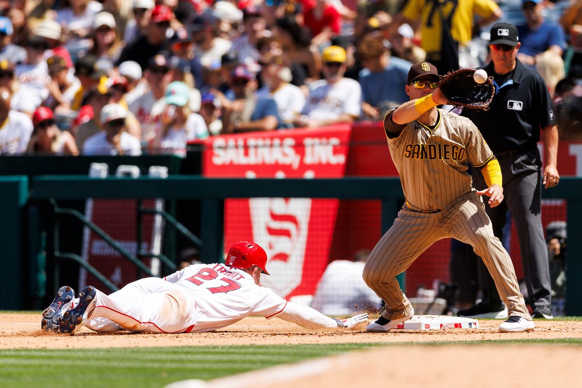 Mike Trout #27 of the Los Angeles Angels dives back to first base against Gavin Sheets #30 of the San Diego Padres during the game at Angel Stadium of Anaheim on April 19, 2026 in Anaheim, California. Mike Trout #27 of the Los Angeles Angels dives back to first base against Gavin Sheets #30 of the San Diego Padres during the game at Angel Stadium of Anaheim on April 19, 2026 in Anaheim, California.