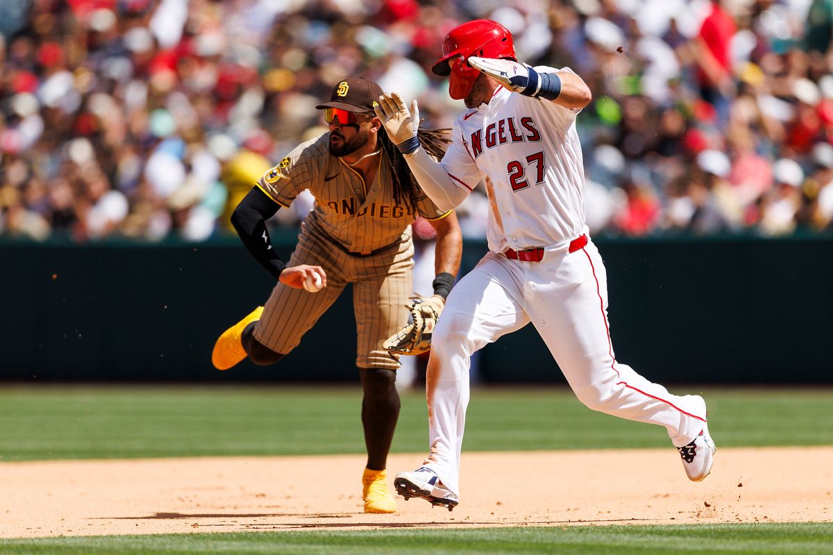 Mike Trout #27 of the Los Angeles Angels runs past Fernando Tatis Jr. #23 of the San Diego Padres as he fields the ball during the game at Angel Stadium of Anaheim on April 19, 2026 in Anaheim, California. Mike Trout #27 of the Los Angeles Angels runs past Fernando Tatis Jr. #23 of the San Diego Padres as he fields the ball during the game at Angel Stadium of Anaheim on April 19, 2026 in Anaheim, California.