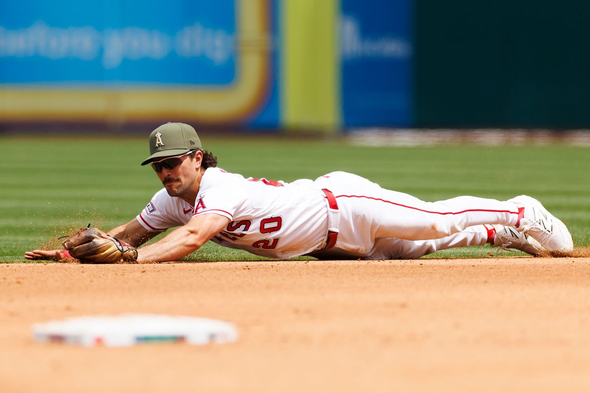 Adam Frazier #20 of the Los Angeles Angels dives for a ground ball during the game against the Los Angeles Dodgers at Angel Stadium of Anaheim on May 17, 2026 in Anaheim, California. Adam Frazier #20 of the Los Angeles Angels dives for a ground ball during the game against the Los Angeles Dodgers at Angel Stadium of Anaheim on May 17, 2026 in Anaheim, California.