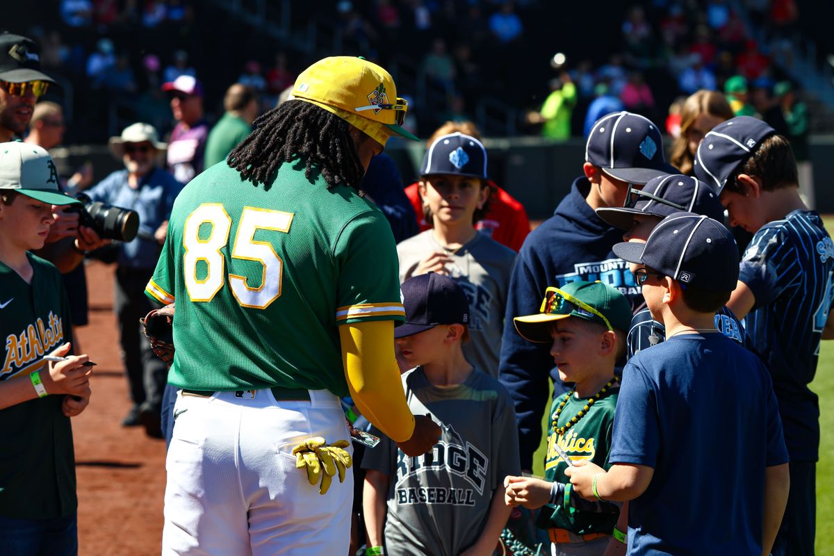 Athletics INF Joshua Kuroda-Grauer (85) signs baseballs for fans prior to an MLB Spring Training game against the Los Angeles Angels on Sunday March 8, 2026, in Las Vegas, Nevada. Athletics INF Joshua Kuroda-Grauer (85) signs baseballs for fans prior to an MLB Spring Training game against the Los Angeles Angels on Sunday March 8, 2026, in Las Vegas, Nevada.