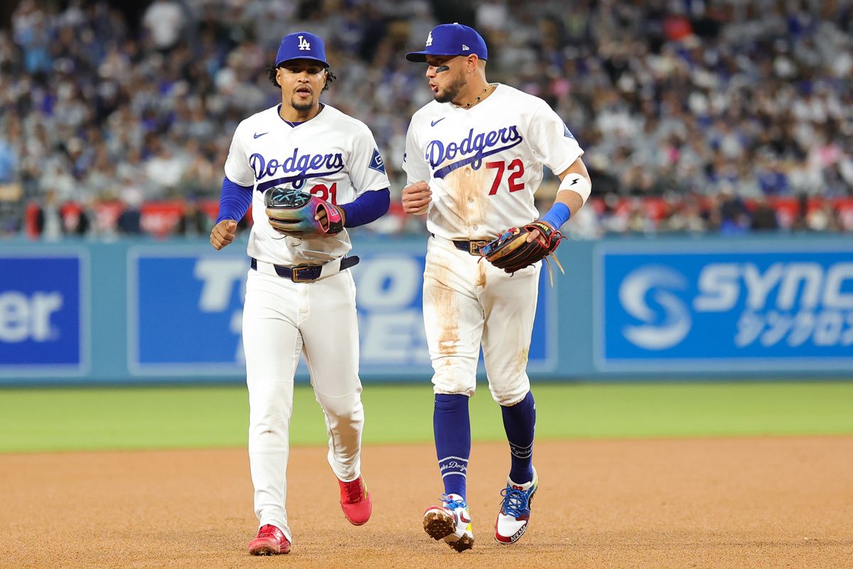 Miguel Rojas #72 and Santiago Espinal #21 of the Los Angeles Dodgers discuss strategy during an MLB game against the New York Mets on April 13, 2026 in Los Angeles, CA. Miguel Rojas #72 and Santiago Espinal #21 of the Los Angeles Dodgers discuss strategy during an MLB game against the New York Mets on April 13, 2026 in Los Angeles, CA.