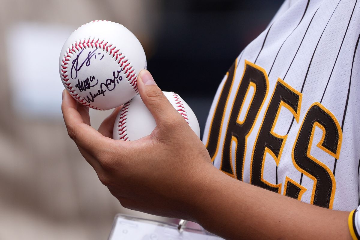 Padres fan holds a signed baseball before an MLB baseball game against the Athletics, Sunday May 24, 2026 in San Diego, California. Padres fan holds a signed baseball before an MLB baseball game against the Athletics, Sunday May 24, 2026 in San Diego, California.