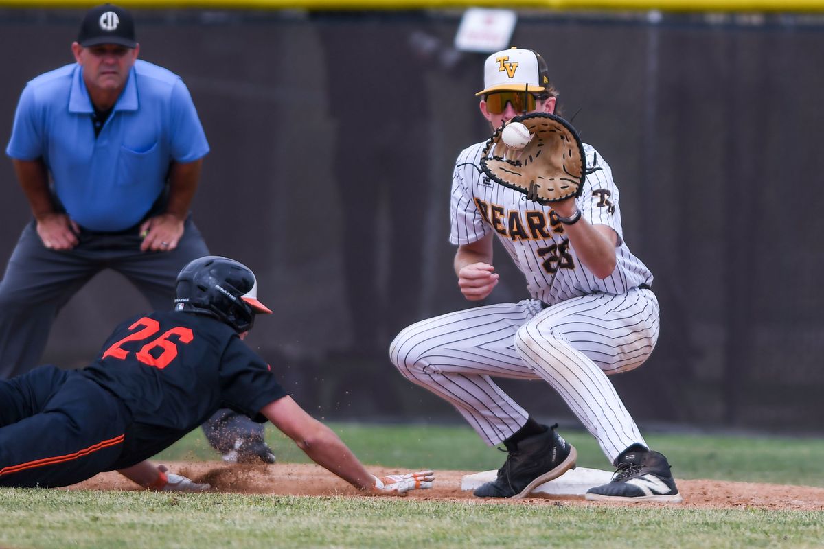 Huntington Beach Tanner Brown (26) dives back to first on a pick off attempt during an High School Baseball game against Temecula Valley Tuesday May 12, 2026 in Temecula, California. Huntington Beach Tanner Brown (26) dives back to first on a pick off attempt during an High School Baseball game against Temecula Valley Tuesday May 12, 2026 in Temecula, California.