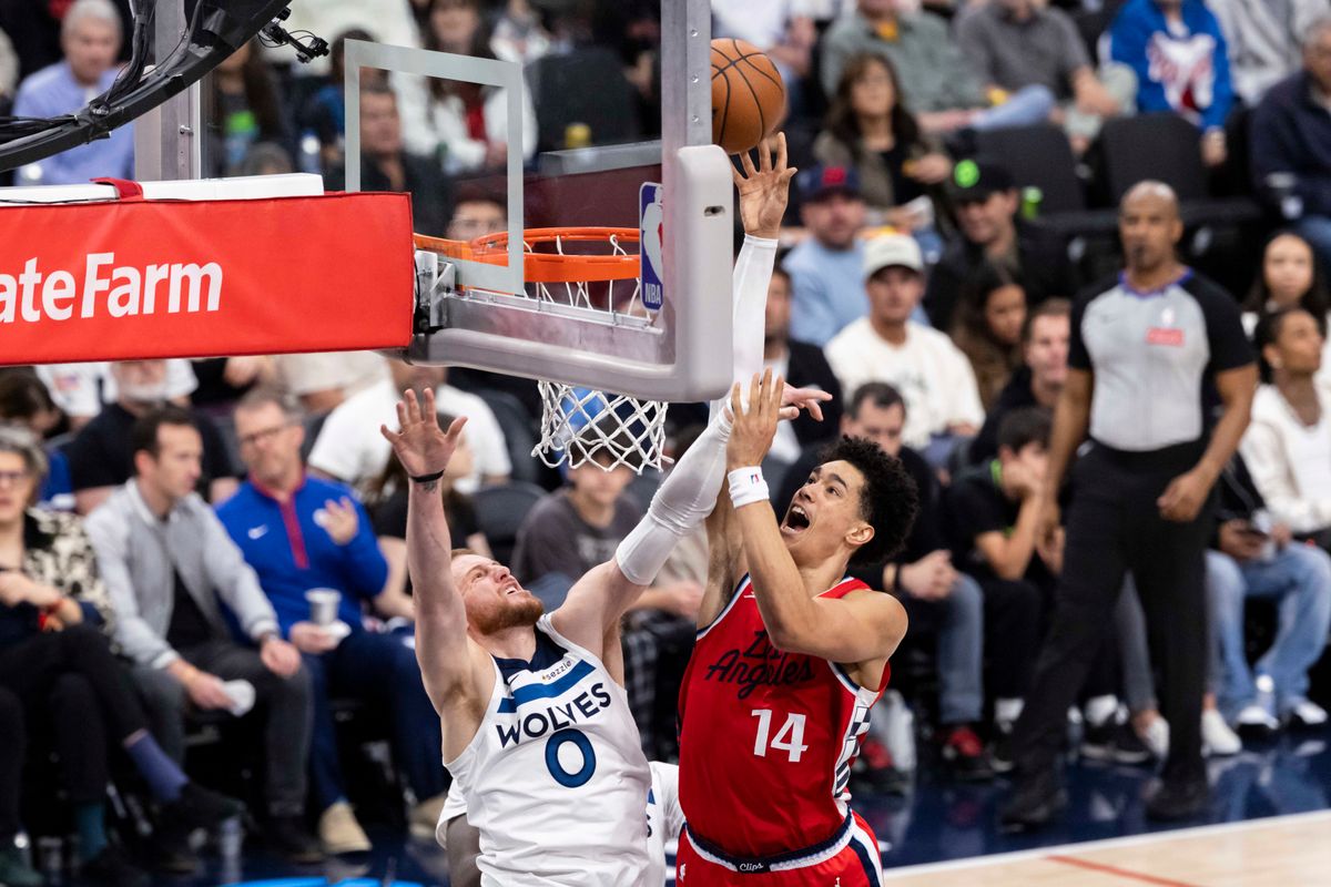 Yanic Konan Niederhauser #14 of the LA Clippers lays the ball up over Donte DiVincenzo #0 of the Minnesota Timberwolves during an NBA basketball game, Thursday February 26, 2026 in Inglewood, Calif. Yanic Konan Niederhauser #14 of the LA Clippers lays the ball up over Donte DiVincenzo #0 of the Minnesota Timberwolves during an NBA basketball game, Thursday February 26, 2026 in Inglewood, Calif.