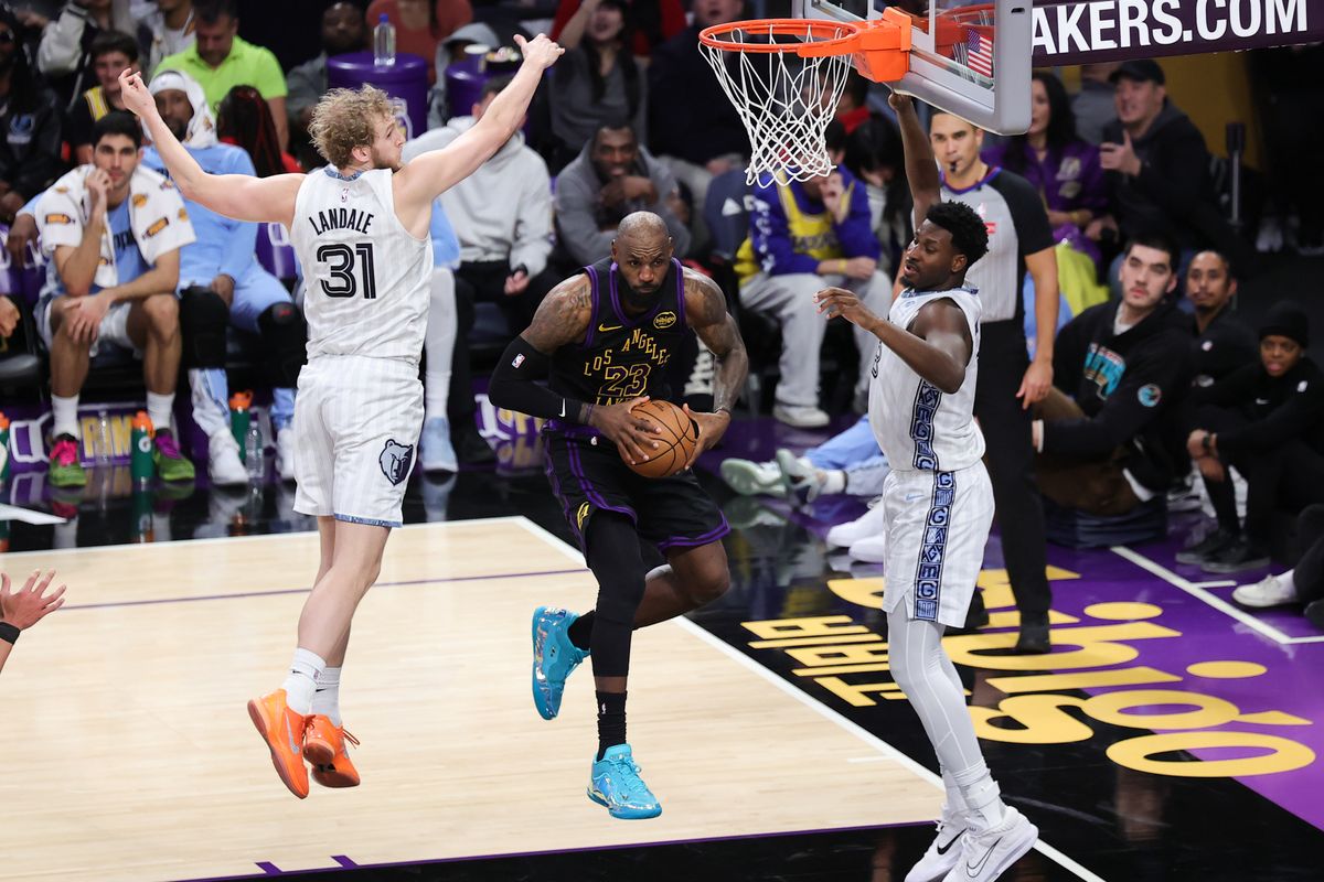 #23 SF LeBron James of the Los Angeles Lakers drives between two defenders during an NBA game against the Memphis Grizzlies on January 2, 2026 in Los Angeles, CA. #23 SF LeBron James of the Los Angeles Lakers drives between two defenders during an NBA game against the Memphis Grizzlies on January 2, 2026 in Los Angeles, CA.