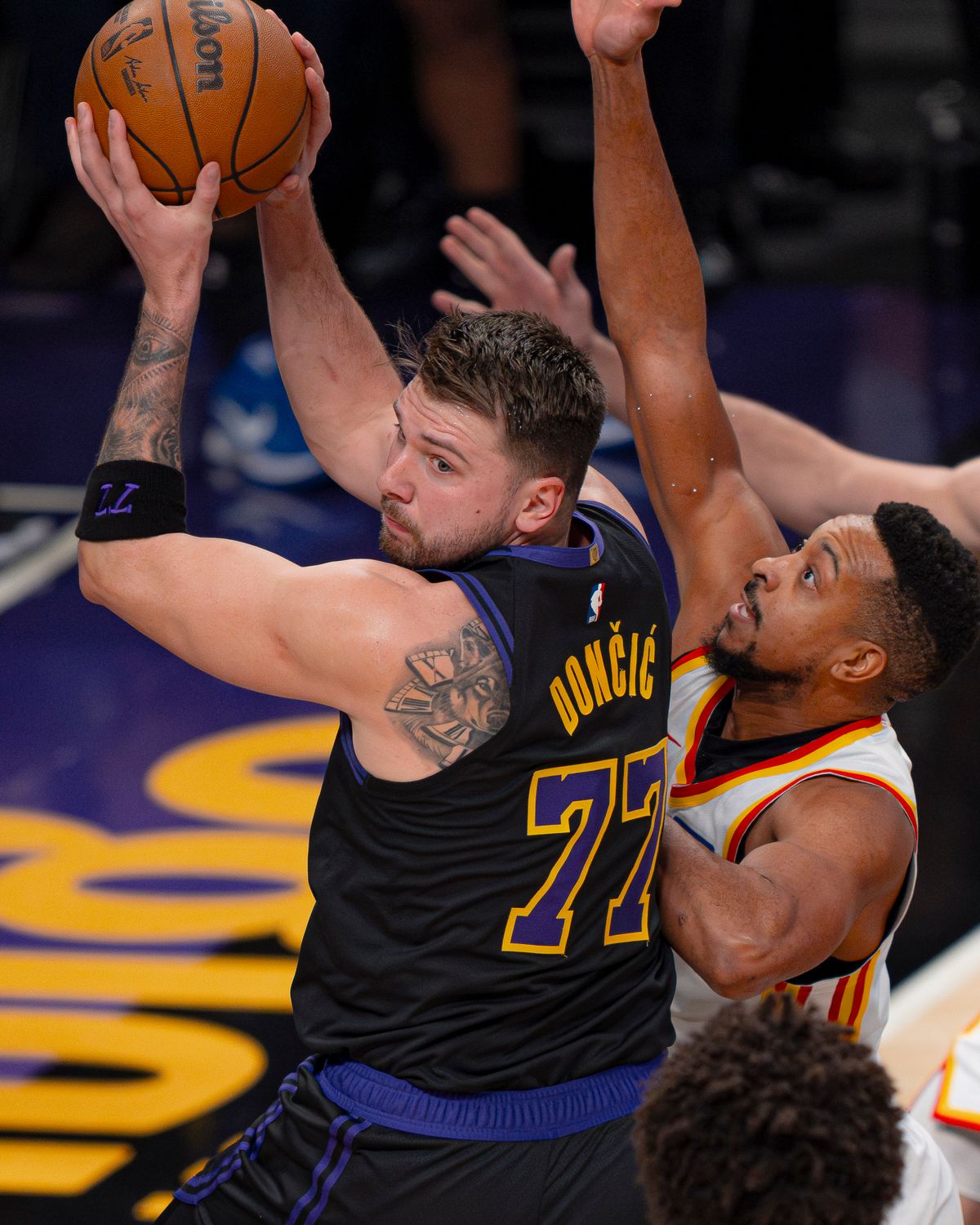 Los Angeles Lakers guard Luka Doncic (77) looking backwards to pass during an NBA basketball game against the Atlanta Hawks on January 13th, 2026 in Los Angeles, CA.