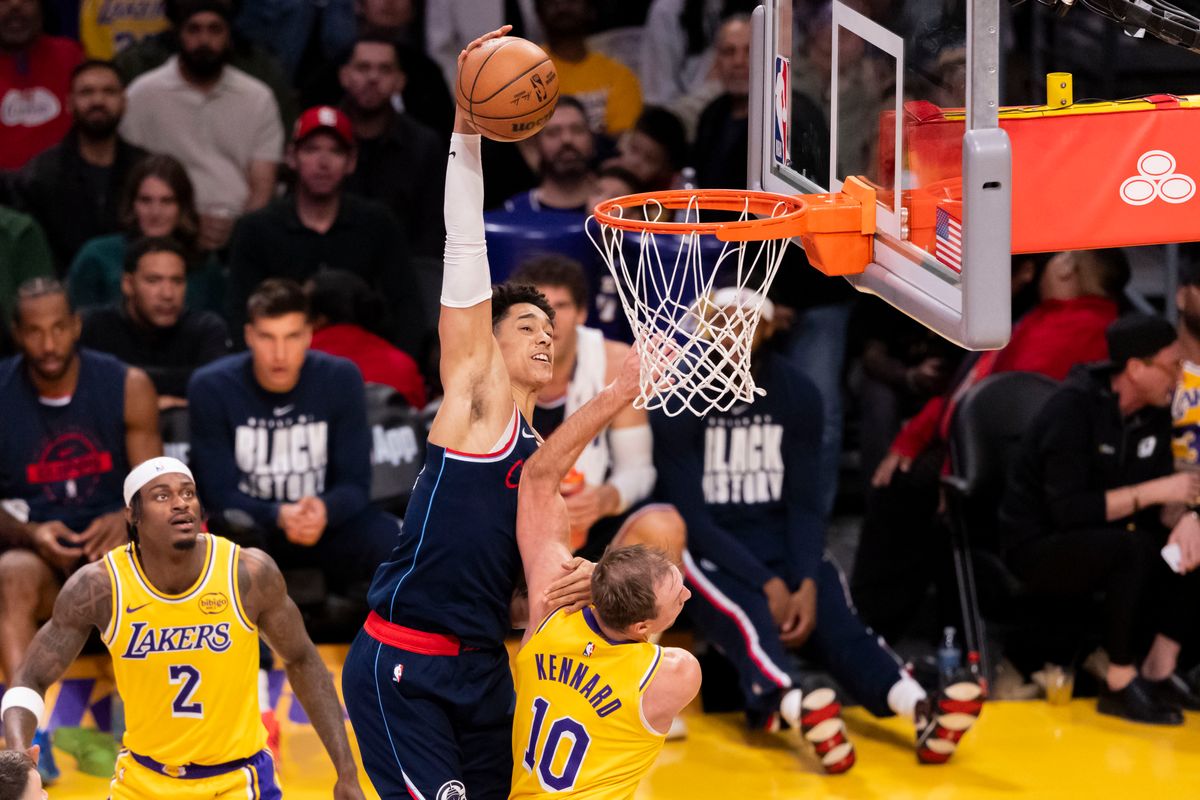 Yanic Konan Niederhauser #14 of the LA Clippers attempts a dunk over Luke Kennard #10 of the Los Angeles Lakers during an NBA basketball game, Friday February 20, 2026 in Los Angeles, Calif.