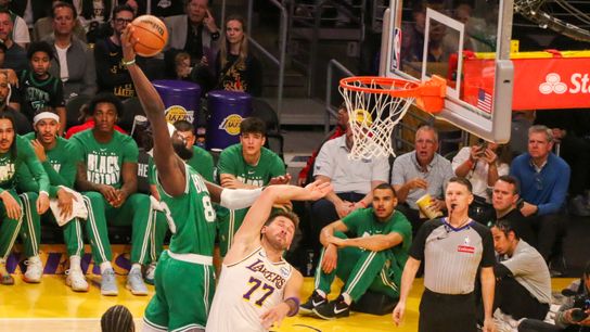 Boston Celtics center Neemias Queta (88) dunks on Los Angeles Lakers guard Luka Doncic (77) during the first quarter at crypto.com Arena. 