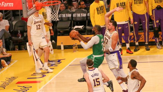 Boston Celtics guard Jaylen Brown (7) attempts a layup as Los Angeles Lakers guard Luka Dončić (77) attempts to block the shot at crypto.com Arena.
