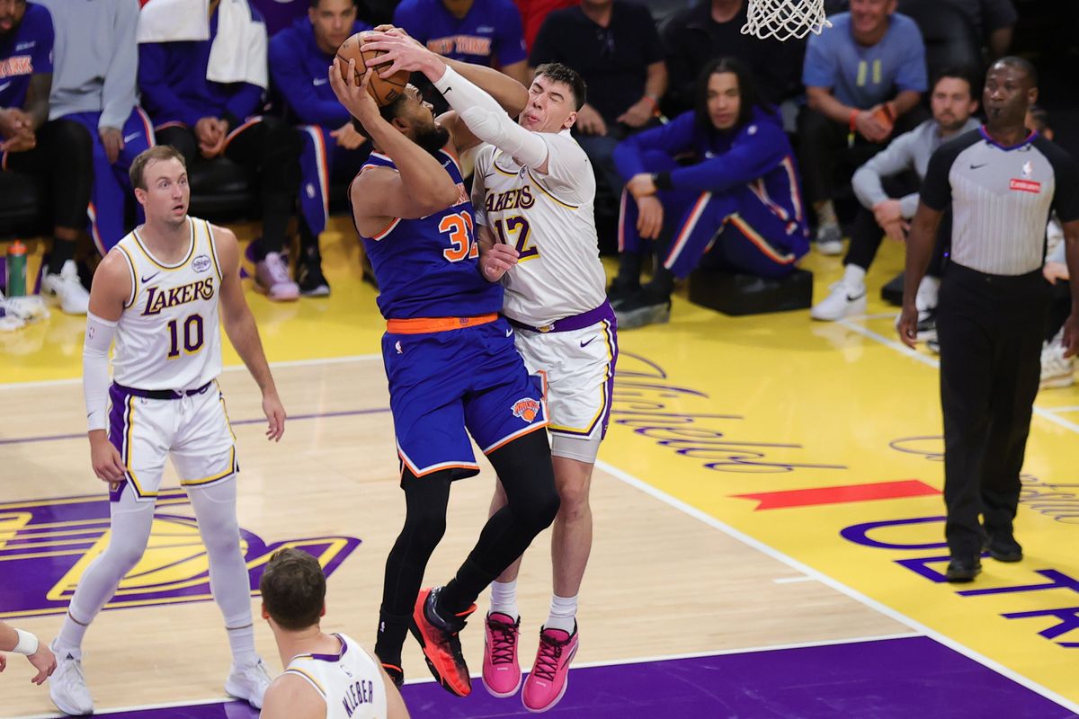 Los Angeles Lakers forward Jake LaRavia (12) defends against New York Knicks center Karl Anthony Townes (32) during an NBA game on March 8, 2026 in Los Angeles, CA. Los Angeles Lakers forward Jake LaRavia (12) defends against New York Knicks center Karl Anthony Townes (32) during an NBA game on March 8, 2026 in Los Angeles, CA.