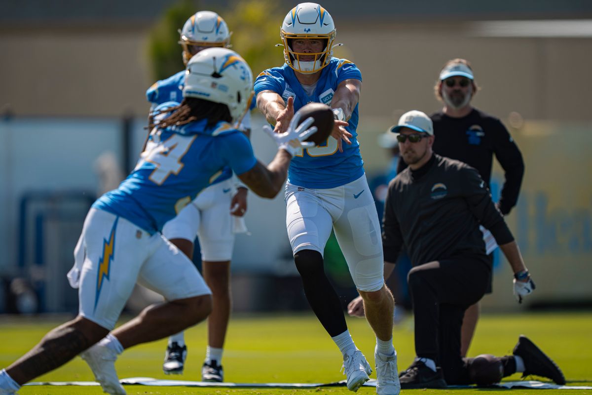 Los Angeles Chargers quarterback Justin Herbert (10) pitching the ball to running back Keaton Mitchell (34) during Chargers training camp at the Bolt on Wednesday, July 29th in El Segundo, CA. Los Angeles Chargers quarterback Justin Herbert (10) pitching the ball to running back Keaton Mitchell (34) during Chargers training camp at the Bolt on Wednesday, July 29th in El Segundo, CA.