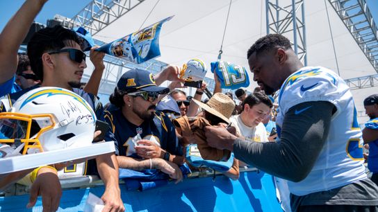 Los Angeles Chargers linebacker Khalil Mack (52) signing merchandise for fans during Chargers training camp at The Bolt on Monday, July 30th in El Segundo, CA. Los Angeles Chargers linebacker Khalil Mack (52) signing merchandise for fans during Chargers training camp at The Bolt on Monday, July 30th in El Segundo, CA.