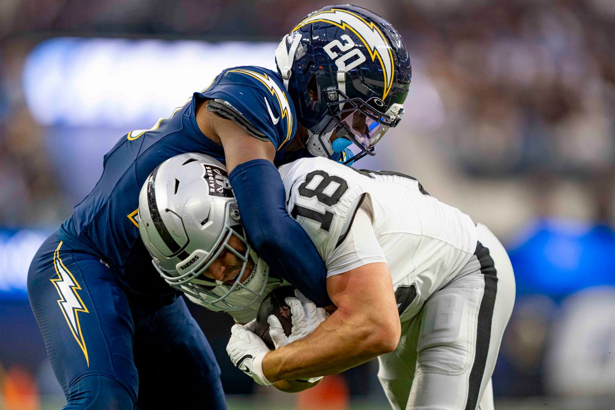 Los Angeles Chargers safety, Cam Hart (20) tackles Jack Bech (18) during an NFL football game against the Las Vegas Raiders on November 30, 2025 in Los Angeles, CA. Los Angeles Chargers safety, Cam Hart (20) tackles Jack Bech (18) during an NFL football game against the Las Vegas Raiders on November 30, 2025 in Los Angeles, CA.